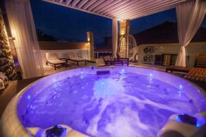 a large jacuzzi tub on a patio at night at Lithos House & Spa in Nafpaktos