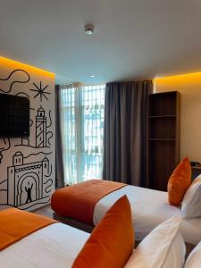 a hotel room with two beds and a fireplace at Le M Neo in Rabat