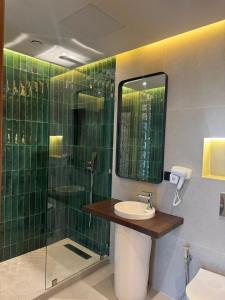 a bathroom with a sink and a shower with a mirror at Le M Neo in Rabat +35 photos
