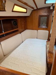 a bed in the back of a boat at Fully equipped sailing boat & exploring zodiac in Nyon