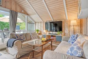 a living room with a couch and a table at C11267-Hemmet-Egernvej-12 in Henne Strand