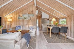 a living room and kitchen in a tiny house at C11267-Hemmet-Egernvej-12 in Henne Strand
