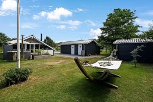 a hammock in the yard of a house at C11267-Hemmet-Egernvej-12 in Henne Strand