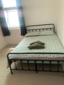 a bed in a bedroom with a pillow on it at Sunny Cottage in Camborne +8 photos