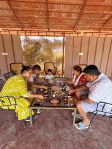 a group of people sitting around a table at Jodhpur Farms in Jodhpur