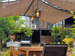 a patio with a table and a laptop on it at good wind 野風楼 in Yawatano