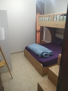 a bedroom with a bunk bed with blue sheets at Azha Townhouse in Ain Sokhna