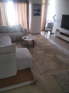 a living room with a couch and a table at Azha Townhouse in Ain Sokhna