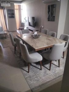 a dining room with a wooden table and chairs at Azha Townhouse in Ain Sokhna