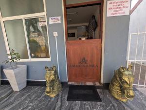 a front door of a restaurant with two animal head statues in front at AmeriLanka Transit Hotel in Seeduwa