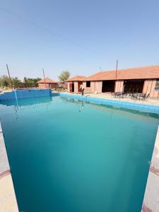 a large pool of water in front of a building at Jodhpur Farms in Jodhpur