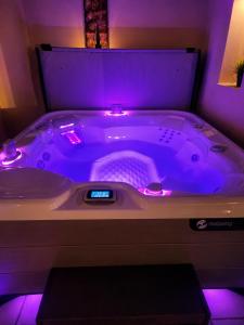 a bath tub with purple lights in a room at Mijas Villa Doña Pilar Pool & Jacuzzi in Mijas