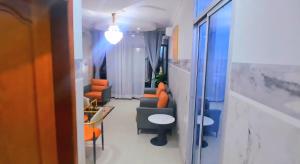 a hallway with chairs and tables in a room at Skyline Guest House in Kinshasa
