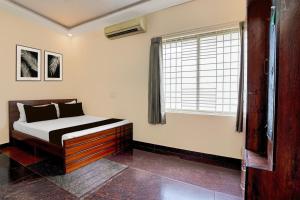 a bedroom with a bed and a window at SPOT ON Sj Comforts Boarding And Lodging in Jigani