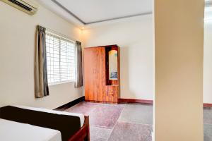 a room with a wooden door and a window at SPOT ON Sj Comforts Boarding And Lodging in Jigani