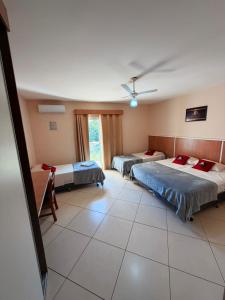a bedroom with two beds and a ceiling at Hotel Canaã Express in Jarinu