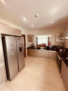 a large kitchen with stainless steel appliances at LUXIRIOUS Homes in Dar es Salaam +31 photos