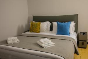 a large bed with two folded towels on it at Lake side Dilijan in Dilijan