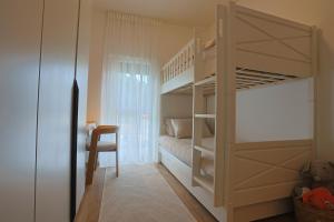 a bedroom with a bunk bed and a desk at Apartman Lami in Krapina