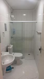 a white bathroom with a toilet and a sink at Hotel Canaã Express in Jarinu +45 photos