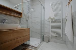 a bathroom with a glass shower and a sink at Apartman Lami in Krapina +21 photos