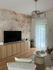 a living room with a flat screen tv on a wall at Apartman Lami in Krapina