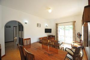a dining room with a table and chairs at GT Self Catering Apartments in Beau Vallon