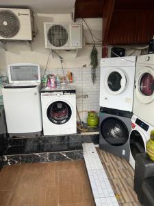 a laundry room with two washing machines and a washer and dryer at De kock Hotel BnB in Bukittinggi +43 photos