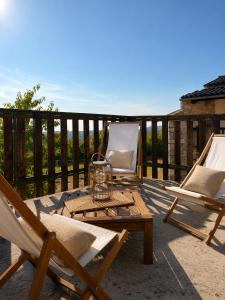 two chairs and a table and two chairs on a patio at Hisa pri Ovcicevih in Komen +5 photos