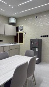 a kitchen with a table and chairs in it at شقة سحاب ابها in Abha
