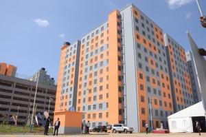 a tall orange building with people standing in front of it at Urban Elegance in Nairobi