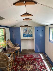 a room with blue cabinets and a table and chairs at Wiesenrand in Neukalen