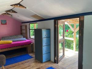 a bedroom with a bed and a room with a window at Wiesenrand in Neukalen
