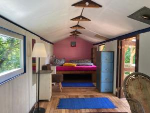 a bedroom with a bed in the corner of a room at Wiesenrand in Neukalen