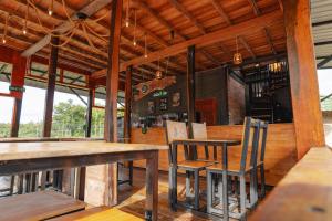 an empty restaurant with wooden tables and chairs at Balian Jus in Tuktuk Siadong +57 photos