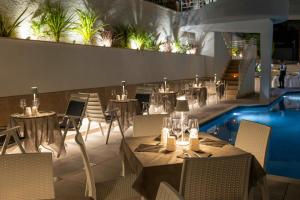 a restaurant with tables and chairs and a swimming pool at Hotel Gaggiano in San Giovanni Rotondo