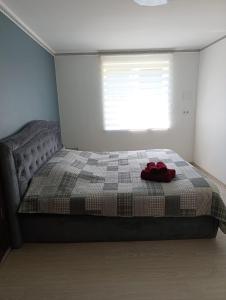 a bedroom with a bed with a red item on it at Rukiši in Saulkrasti +11 photos