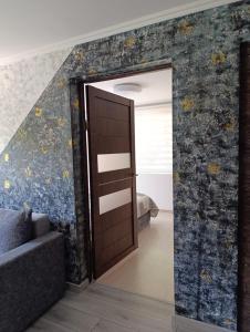 a room with a door leading to a bedroom at Rukiši in Saulkrasti