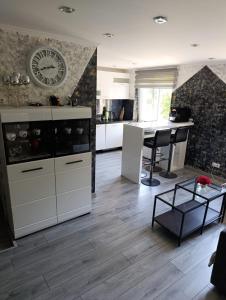 a kitchen with white cabinets and a table at Rukiši in Saulkrasti