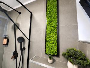 a green wall with plants on a wall at Norway Cabins Sinaia Romantic Nordic Escape and Fire Pit in Sinaia +49 photos