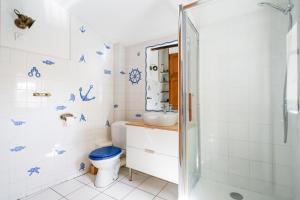 a bathroom with a toilet and a sink at La Cerisaie in Lyon +36 photos