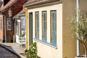 a house with blue windows on the side of it at AE330-Aeroskobing-Ostergade-8 in Ærøskøbing +4 photos