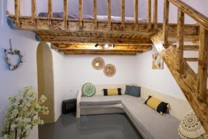 a room with a bed under a wooden stairs at Loft Kaves Pool & Bar Suites in Pyrgos +64 photos