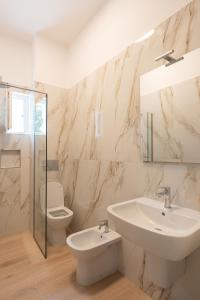a white bathroom with a sink and a toilet at Residence La Scogliera in Alassio +102 photos