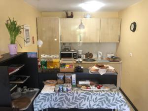 a kitchen with a table with food on it at Le Relais des Templiers in Villecroze +20 photos