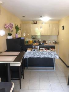 a kitchen with a table with a cloth on it at Le Relais des Templiers in Villecroze