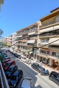 a city street with cars parked in a parking lot at Lyda Apartment in Alexandroupoli