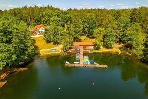 an aerial view of a dock in the middle of a lake at Przystań Narie in Kretowiny