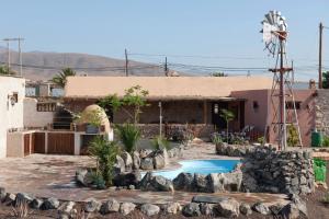 a house with a swimming pool in the yard at Canary House With Heated Pool in Tuineje