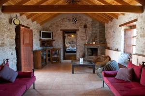a living room with red couches and a fireplace at Canary House With Heated Pool in Tuineje